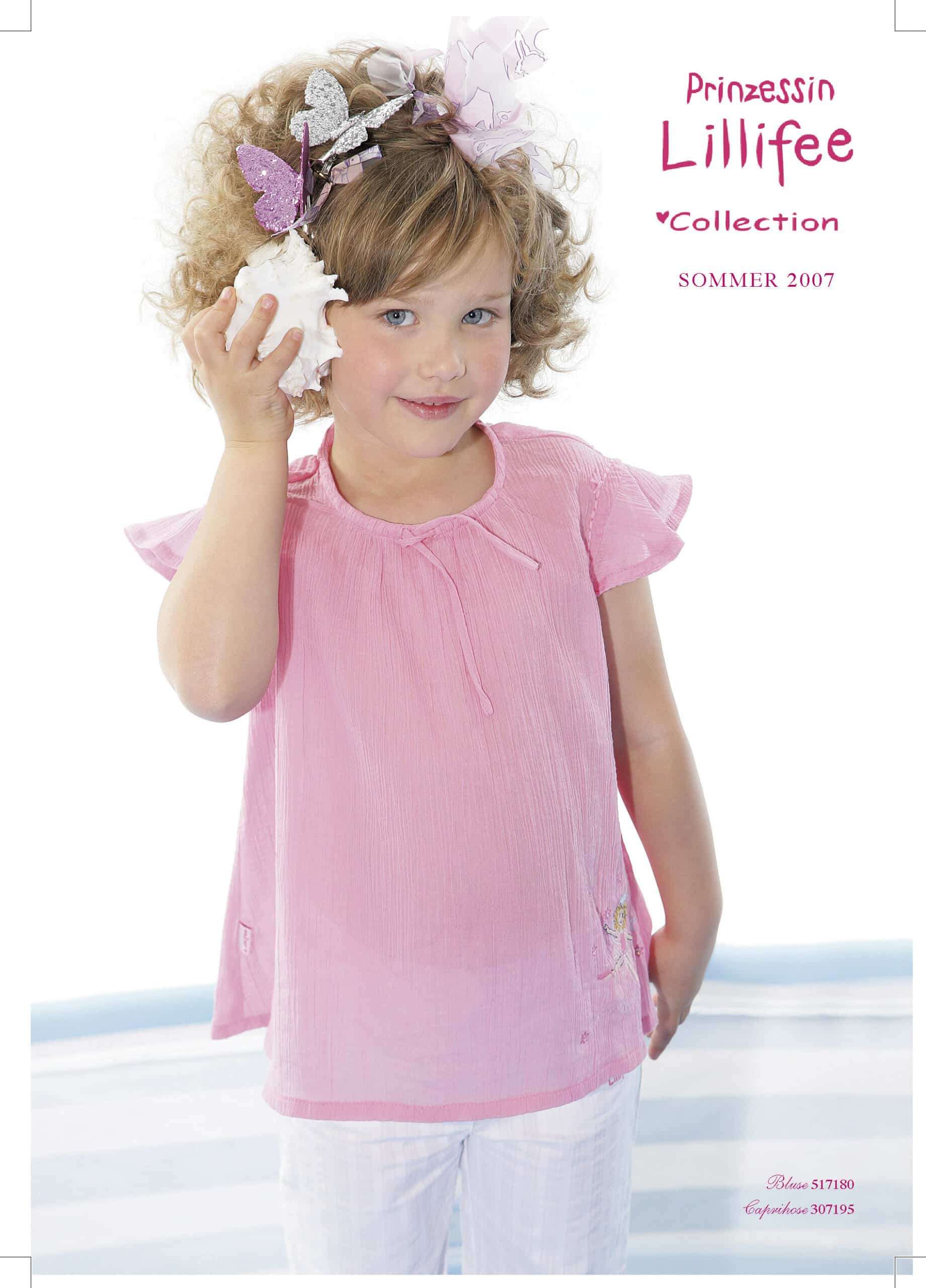 Ein junges Mädchen mit lockigem Haar, einem rosa T-Shirt und einer Muschel in der Hand steht lächelnd vor einem weißen Hintergrund. Sie hat Schmetterlingsspangen im Haar. Der Text lautet „Prinzessin Lillifee Kollektion Sommer 2007“. © Fotografie Tomas Rodriguez